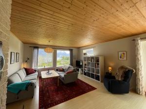 a living room with a couch and a table at Spacious House with Fjordview in Lauvstad