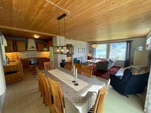 a kitchen and dining room with a table and chairs at Spacious House with Fjordview in Lauvstad