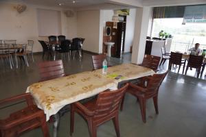 a dining room with a table and chairs and a room with tables and chairsktop at Hotel Raj Resort and Pool in Dogeta
