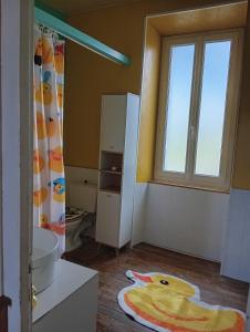 a bathroom with a toilet and a window at Maison de campagne in Maussac +9 photos