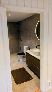 a bathroom with a tub and a sink and a toilet at Backahöjd Holidays in Rävlanda +18 photos