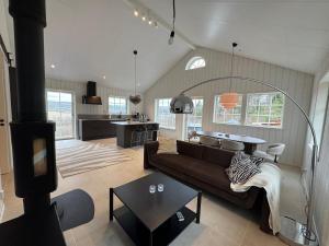 a living room with a couch and a table at Backahöjd Holidays in Rävlanda