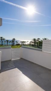 a white wall with a view of the ocean at Terrazza Suites in Paphos