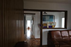 a living room with a couch and a hallway at AL Penedo da Cheira in Penacova