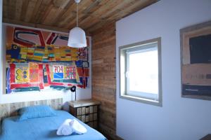 a bedroom with a blue bed and a window at AL Penedo da Cheira in Penacova