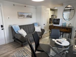 a living room with a couch and a table at Salty & Sweet 303 in Old Orchard Beach