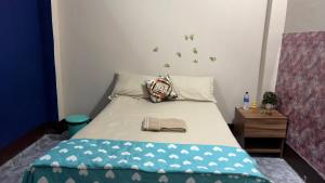 a bedroom with a bed with a blue comforter at The Glory Apartment room 2 in Imphal
