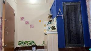 a hallway with a blue wall and a door at The Glory Apartment room 2 in Imphal