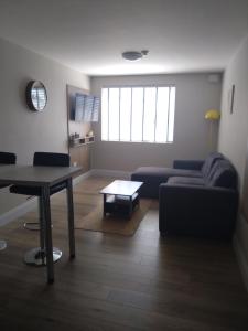 a living room with a couch and a table at Codladh Samh Apartment No 2 in Templemore