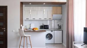 a kitchen with a washing machine and a washer at 40 m2 Confort apartament in Bălţi