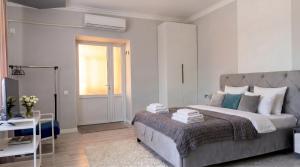 a bedroom with a bed and a table and a window at 40 m2 Confort apartament in Bălţi