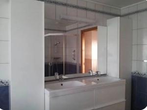 a bathroom with a sink and a mirror at Rolig sted ved havet in Sirevåg +15 photos