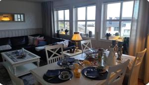 a living room with a table and a couch at Rolig sted ved havet in Sirevåg