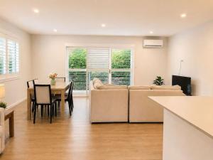 a living room with a couch and a table at 21 Pimpama Home in Pimpama