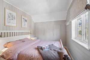 a bedroom with a bed with a blanket on it at The Reine Scenic View in Moskenes