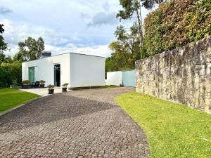 a white house with a stone wall at Ednas Place - Tranquilidade e Natureza in Caminha