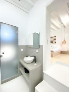a bathroom with a sink and a mirror at Villa Loom Mykonos Town in Mikonos +19 photos