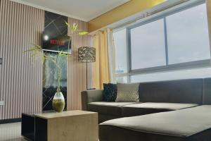 a living room with a couch and a window at Puerto Santa Ana, river view 102 in Guayaquil