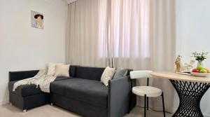 a living room with a couch and a table at Status center in Bălţi
