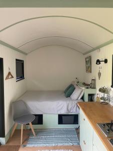a bedroom with a bed in a small room at Apple Orchard Shepherd Huts in Staple Cross