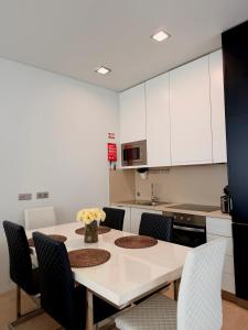 a kitchen with a table and chairs in a kitchen at Ednas Place - Tranquilidade e Natureza in Caminha