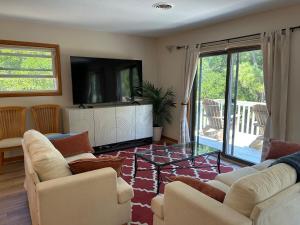 a living room with two couches and a flat screen tv at 3BR 3BA Beach House in Kitty Hawk Beach
