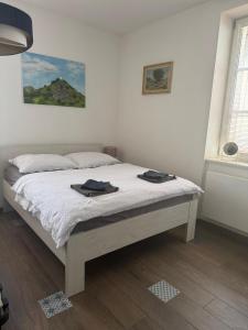 a bedroom with a bed with two towels on it at Apartmán Augustin Jičín in Jičín