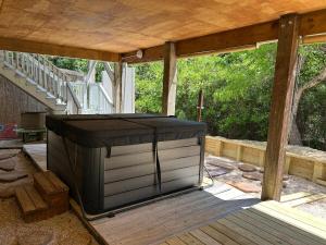 a screened in porch with a large tv on it at 3BR 3BA Beach House in Kitty Hawk Beach