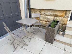a table and two chairs on a patio at Apartmán Augustin Jičín in Jičín