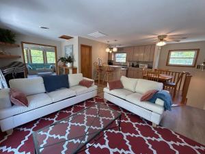 a living room with two white couches and a kitchen at 3BR 3BA Beach House in Kitty Hawk Beach