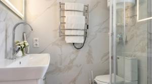 a bathroom with a shower and a sink and a toilet at Status center in Bălţi