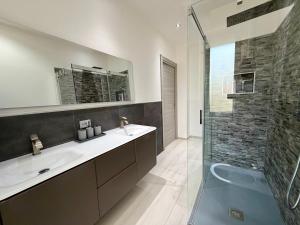 a bathroom with a sink and a glass shower at Wake to Lake - Arona, Lago Maggiore in Arona