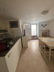 a kitchen and dining room with a table and a kitchen and a table and chairs at Casa Luisa in Peschici +2 photos