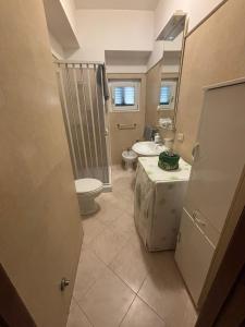 a bathroom with a shower and a toilet and a sink at Casa Luisa in Peschici