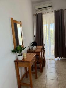 a dining room with a table and a mirror at Zografos 5 in Haraki