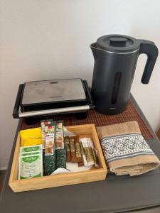 a table with a tray of food and a coffee pot at Zografos 5 in Haraki