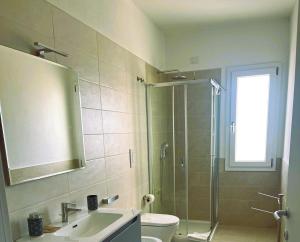 a bathroom with a shower and a sink and a toilet at Il PuntoPiu'Alto in SantʼAntìoco