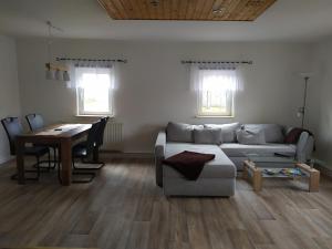 a living room with a couch and a table at Ferienwohnung Schwerg in Hohnstein