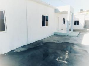 an empty room with a concrete floor and white walls at Blue Song Villa in Braco