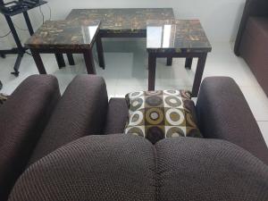 a living room with a couch and two tables at Blue Song Villa in Braco