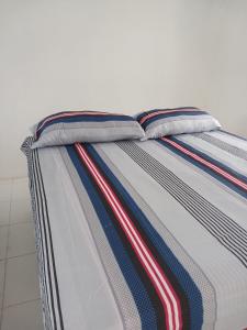 a bed with two pillows on top of it at Blue Song Villa in Braco