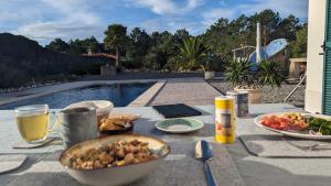 a table with a bowl of food and drinks on it at Villa Atlantico in Aljezur