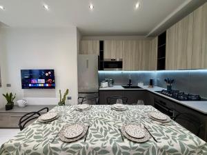 a kitchen with a table with plates on it at Wake to Lake - Arona, Lago Maggiore in Arona