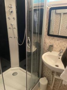 a bathroom with a shower and a sink at Mókus Pagony 2pont0 in Zánka +14 photos