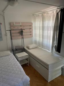 a small bedroom with a bed and a window at Mókus Pagony 2pont0 in Zánka