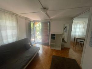 a living room with a couch and a table at Mókus Pagony 2pont0 in Zánka