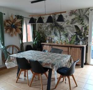 a dining room with a table and chairs in a room at Maison de campagne in Capelle-Fermont