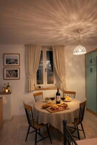 a dining room with a table with food and wine at Villa Rosa in Ravno +57 photos
