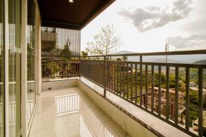 a balcony with a view of the mountains at Shree Goljyu Palace in Almora