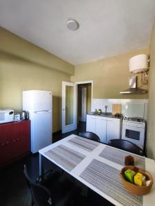 a kitchen with a table with a bowl of fruit on it at Libertador 2 in Montevideo
